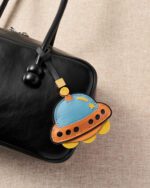 Handmade Leather UFO Spaceship Charm (Vibrant Blue & Orange Version) - Image 2